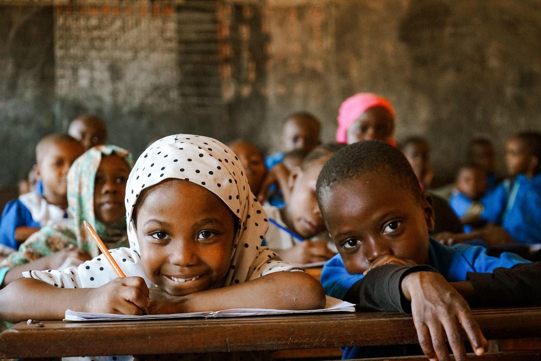 A child back at school — the outcome a gift makes possible.
