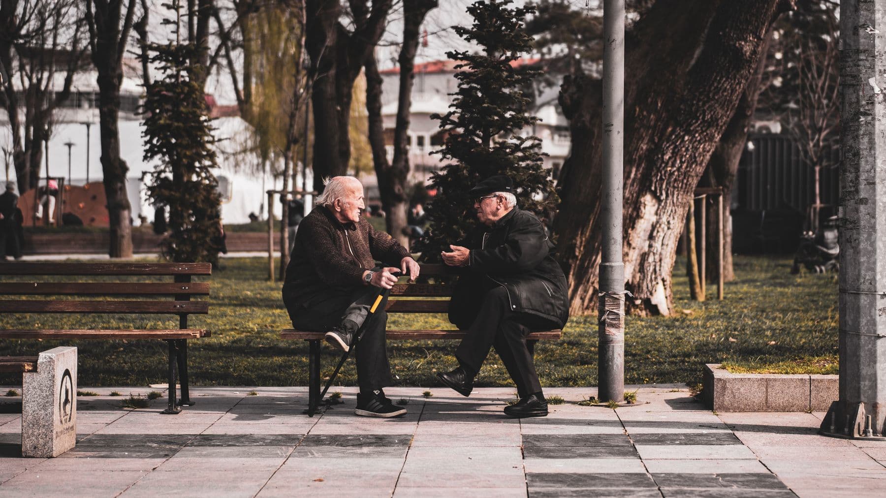 Two people in a calm, unhurried conversation on a park bench.
